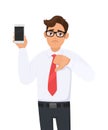 Unhappy business man showing new brand, latest smartphone. Man holding cell, mobile phone in hand and making thumbs down. Royalty Free Stock Photo