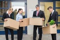 Unhappy Businesspeople With Cardboard Boxes Outside The Office Royalty Free Stock Photo