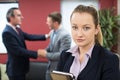 Portrait Of Unhappy Businesswoman With Male Colleague Being Cong