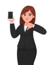 Unhappy businesswoman showing blank screen mobile, cell or smart phone and gesturing or making thumbs down sign. Dislike, no deal.