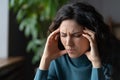 Unhappy businesswoman suffer from strong headache touch temples exhausted from stress at workplace Royalty Free Stock Photo