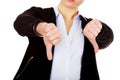 Unhappy businesswoman with thumbs down gesture