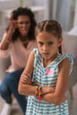 Unhappy cheerless girl listening to her mother