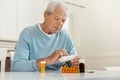 Unhappy cheerless man taking medicine