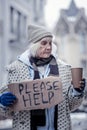 Unhappy cheerless woman standing on the street