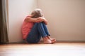 Unhappy Child Sitting On Floor In Corner At Home Royalty Free Stock Photo