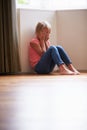 Unhappy Child Sitting On Floor In Corner At Home Royalty Free Stock Photo