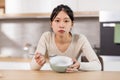 Unhappy chinese woman showing her empty plate