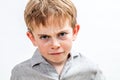 Unhappy conflicted child expressing sadness, anger and disappointment, isolated Royalty Free Stock Photo