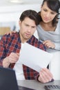 unhappy couple arguing about money bills documents