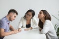 Unhappy couple getting divorced, husband signing papers in lawye Royalty Free Stock Photo