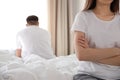 Unhappy couple with problems in relationship on bed at home Royalty Free Stock Photo