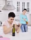 Unhappy couple red vine in the kitchen Royalty Free Stock Photo