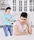 Unhappy couple red vine in the kitchen Royalty Free Stock Photo