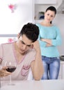 Unhappy couple red vine in the kitchen Royalty Free Stock Photo