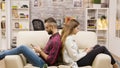 Unhappy couple sitting back to back on the couch Royalty Free Stock Photo