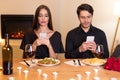 Unhappy Couple Using Mobile Phones Bored On Date Royalty Free Stock Photo