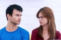 Unhappy couples at home. man and beautiful young woman are looking offended at each other while having a quarrel. Couple Royalty Free Stock Photo