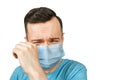 Unhappy, cry young man wearing a protective face mask prevent virus infection or pollution on white isolated background Royalty Free Stock Photo