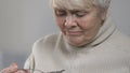 Unhappy crying woman eating tasty porridge in nursing home, feeling homesick