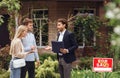 Unhappy customers arguing with property manager about house purchase outdoors, empty space Royalty Free Stock Photo
