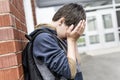 Unhappy Pre teen boy at school Royalty Free Stock Photo