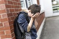 Unhappy Pre teen boy at school Royalty Free Stock Photo