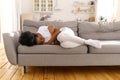 Depressed unhappy Black woman lying on couch at home, crying, suffering from divorce or break up. Royalty Free Stock Photo