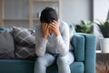 Unhappy depressed Indian woman holding head in hands, sitting alone Royalty Free Stock Photo