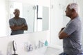 Unhappy Depressed Senior Man Looking At Reflection In Bathroom Mirror Royalty Free Stock Photo