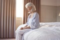 Unhappy And Depressed Senior Woman Sitting On Edge Of Bed At Home Royalty Free Stock Photo
