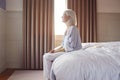 Unhappy And Depressed Senior Woman Sitting On Edge Of Bed At Home Royalty Free Stock Photo