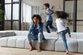 Unhappy young African American mother irritated by loud kids. Royalty Free Stock Photo