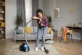 Unhappy despaired tired millennial african american housewife rest with vacuum cleaner from cleaning