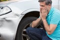 Unhappy Driver Inspecting Damage After Car Accident Royalty Free Stock Photo