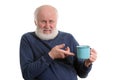 Unhappy elderly man with cup of bad tea or coffee isolated on white