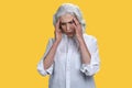 Unhappy elegant senior woman suffering from headache on color background. Royalty Free Stock Photo