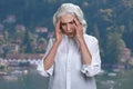 Unhappy elegant senior woman suffering from headache outdoors. Royalty Free Stock Photo