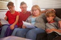 Unhappy Family Sitting On Sofa Looking At Bills Royalty Free Stock Photo
