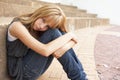 Unhappy Female Teenage Student Sitting Outside