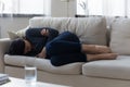 Unhappy frustrated Asian young woman lying on couch alone