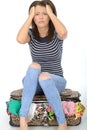 Unhappy Frustrated Attractive Young Woman Sitting on an Overflowed Suitcase Royalty Free Stock Photo