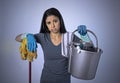 Unhappy and frustrated housekeeping woman holding mop and wash bucket as hotel cleaner service or house maid Royalty Free Stock Photo