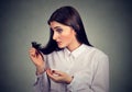 Unhappy frustrated woman surprised she is losing hair, noticed split ends Royalty Free Stock Photo