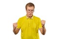 Unhappy geek guy in glasses and yellow T-shirt ready to fight with fists isolated white background Royalty Free Stock Photo