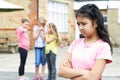 Unhappy Girl Being Gossiped About By School Friends Royalty Free Stock Photo