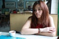 Unhappy Girl in chinese restaurant wait someone who late Royalty Free Stock Photo