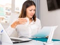 Unhappy girl manager reading documents, holding napkin in office Royalty Free Stock Photo