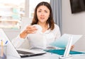 Unhappy girl manager reading documents, holding napkin in office Royalty Free Stock Photo