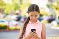 Unhappy girl reading text message on smart phone Royalty Free Stock Photo